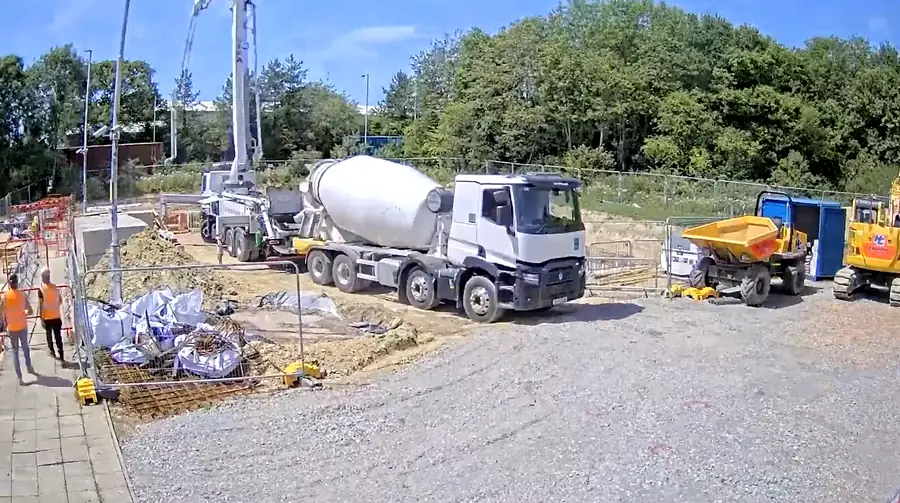 Concrete mixer and pump pouring the base htmlFor a new substation