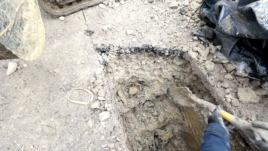 Hand excavation of a service trial hole through concrete hardstanding